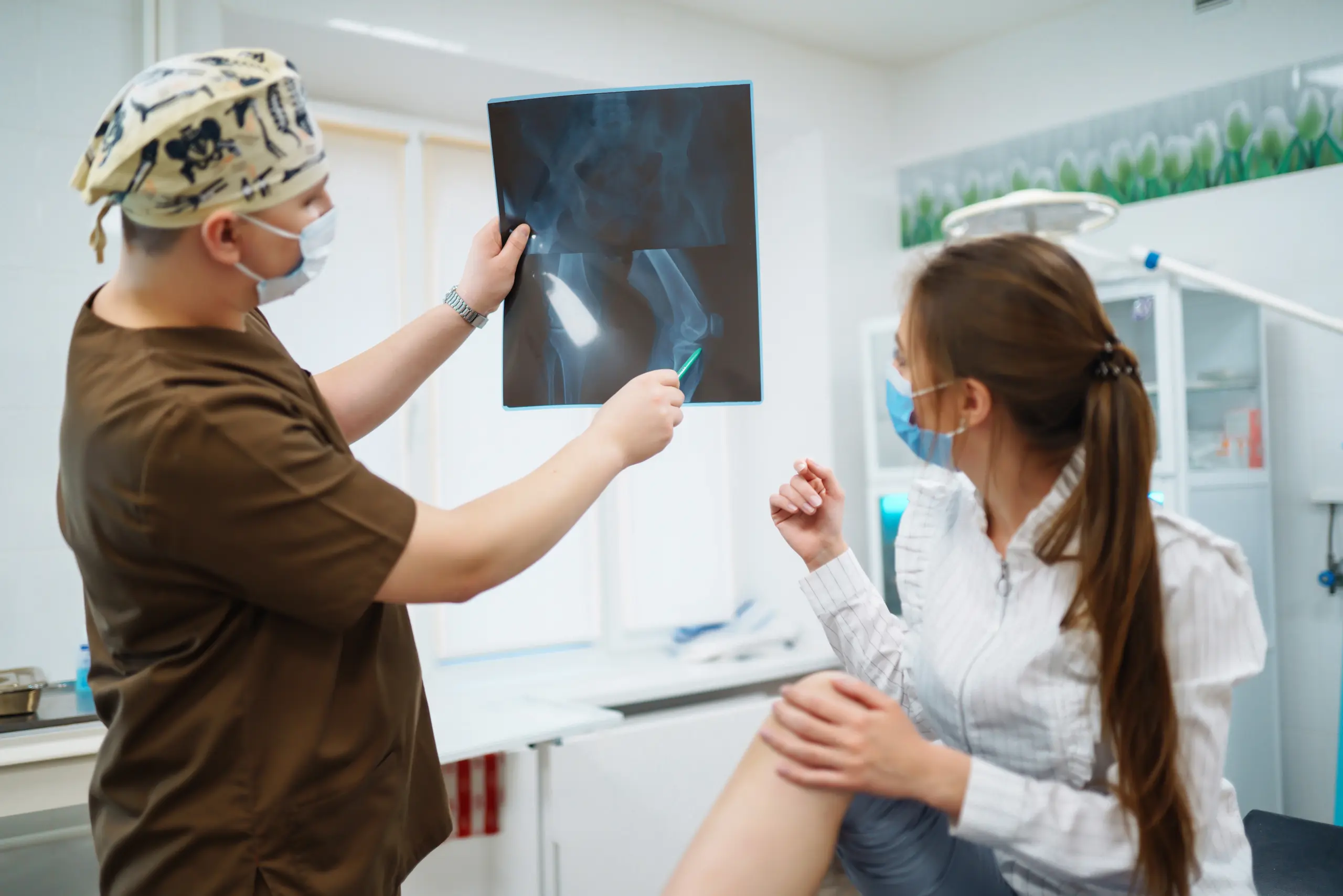 Orthopedic surgeon examining a patient's knee for signs you need knee replacement surgery