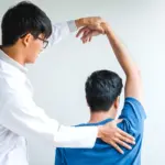 Shoulder replacement surgeon in Raghuvanahalli examining a patient's shoulder joint